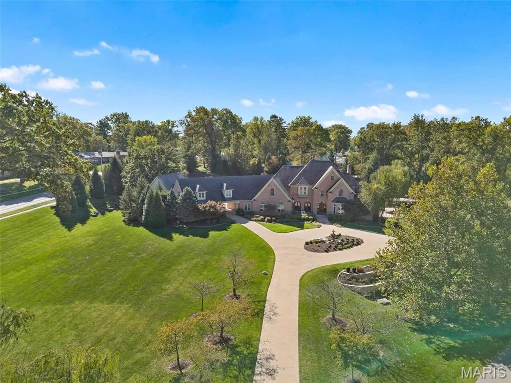 Aerial view of a secluded residential property with a long drive in Clarkson Valley