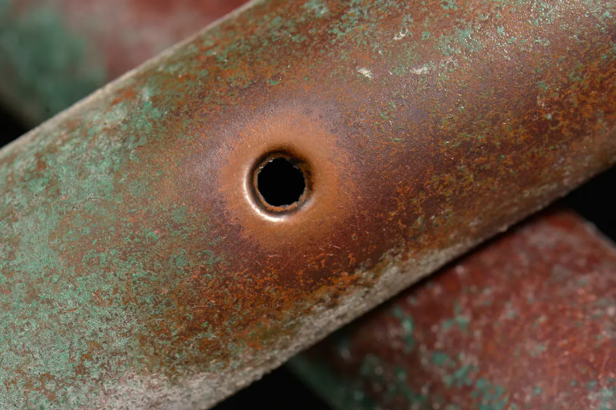 Corroded pipe section with a pinhole leak cut away for repair