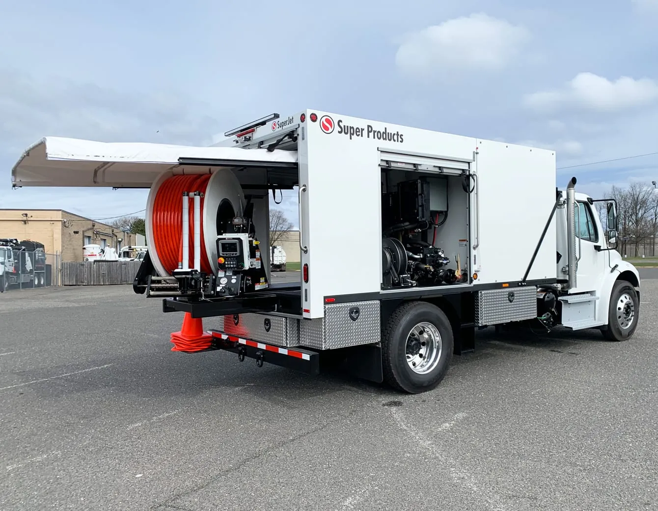 Hydro jetting truck with hose reel staged for sewer cleaning in St. Louis County
