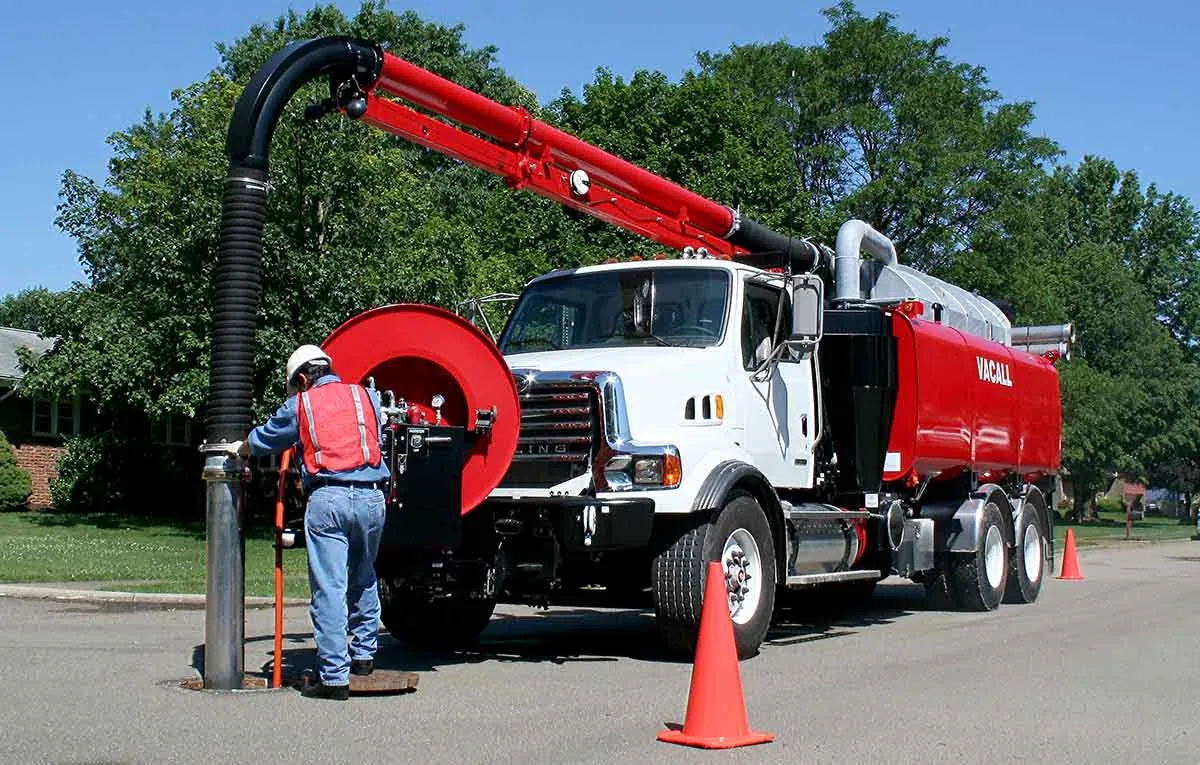 Sewer repair truck and crew working at a residential excavation site in St. Louis County