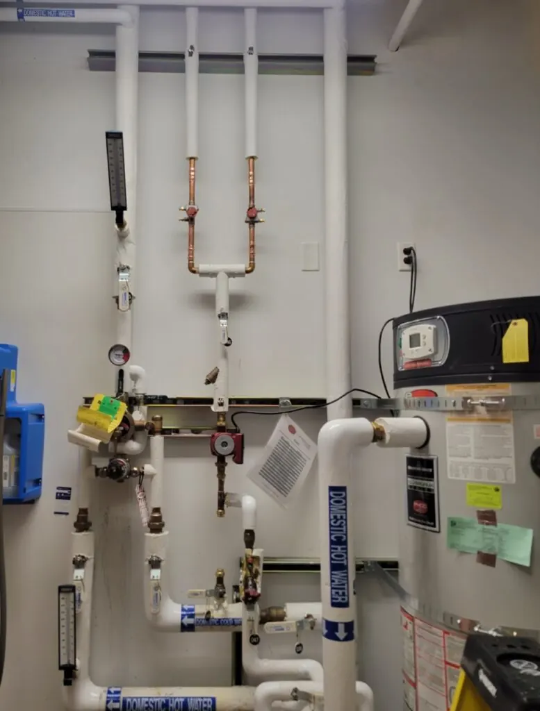 Copper supply piping above a water heating installation